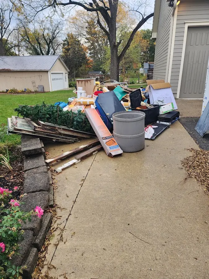 Dumpster being loaded with debris for Estate Cleanout Dumpster Rental in Hopkinsville